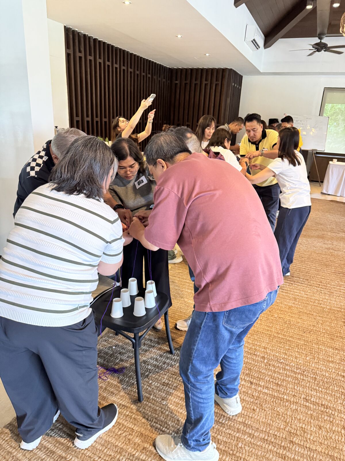 Global Payments leaders pulling strings together to stack paper cups during the Cups Up challenge